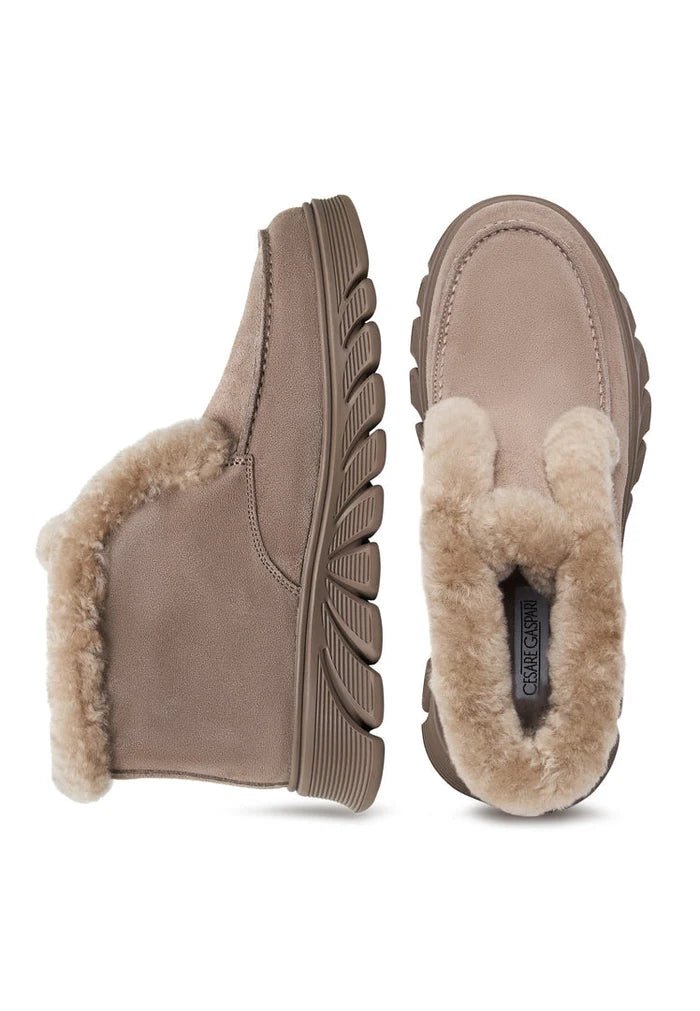 A stylish pair of taupe shearling-lined ankle boots, known as Adriana Brown boots, perfect for women's shearling-lined footwear collection.