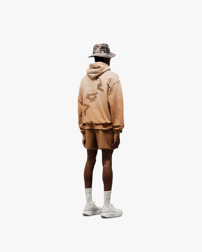 Man wearing rust shorts on a plain white background | Team 247 Aero Shorts in Rust | Lightweight breathable shorts with branded waistband | 247 Shorts | Represent Clo