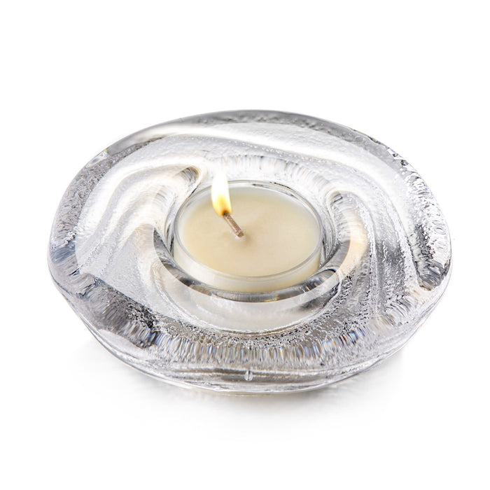 Cream tealight candle in clear glass holder with textured silver-gray outer dish.