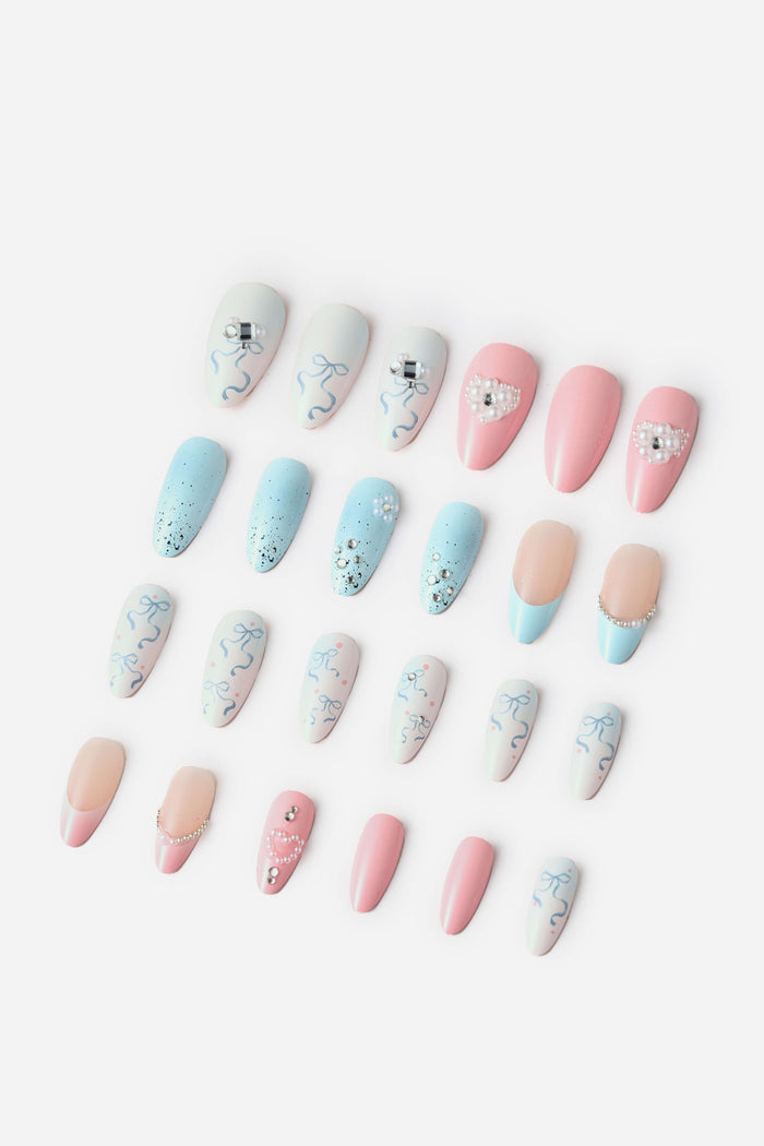 Pastel gradient almond press-on nails with bow and heart designs, adorned with pearls and rhinestones.