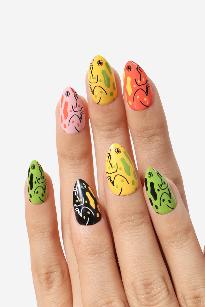 Almond-shaped press-on nails with colorful frog designs by Lorien Stern.