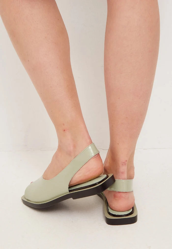 A stylish pair of open toe leather sandals, perfect for summer days in the city, offering a trendy and fashionable look in urban footwear.