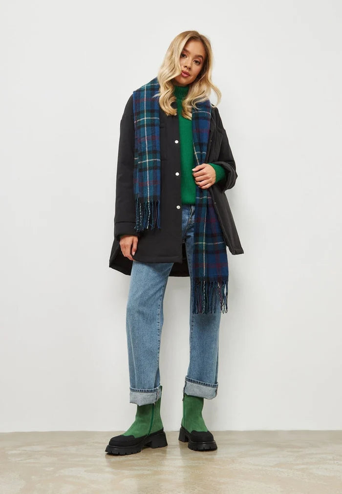 A pair of stylish green urban platform ankle boots for women, making a fashionable statement in footwear.