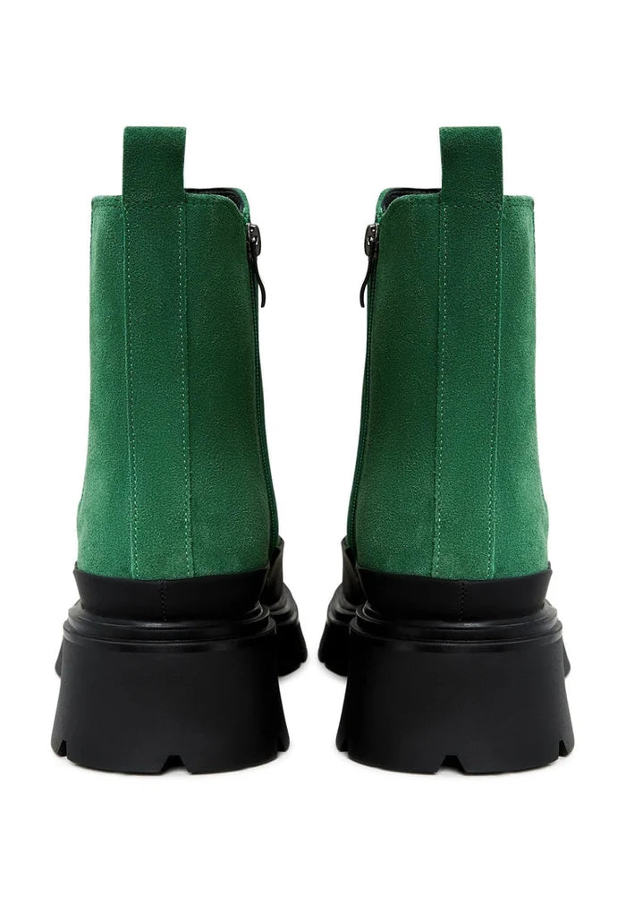 A pair of stylish green urban platform ankle boots for women, the perfect fashionable footwear choice.