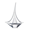 Clear glass sailboat sculpture with tall mast and curved hull base.