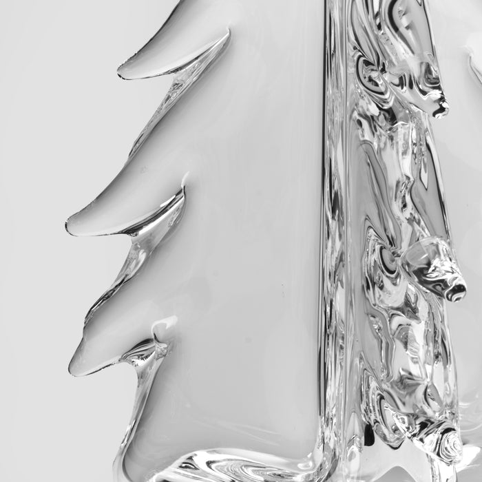 Clear glass spreader knives with ornate handles arranged next to a decorative glass box.