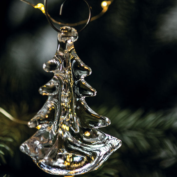 Silver-toned metallic evergreen tree ornament with gold accents, hanging from a dark cord with gold caps.