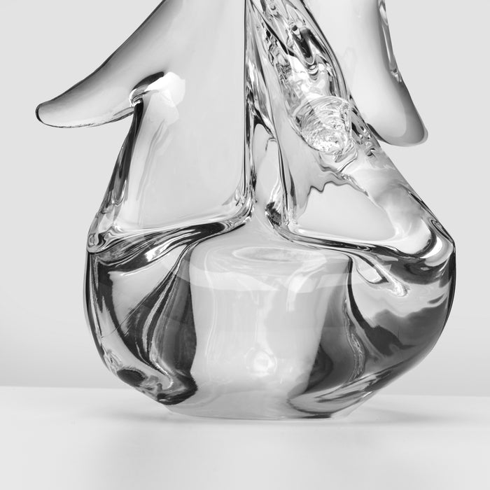 Clear glass candle holder with twisted design and white candle inside, shown against white background.