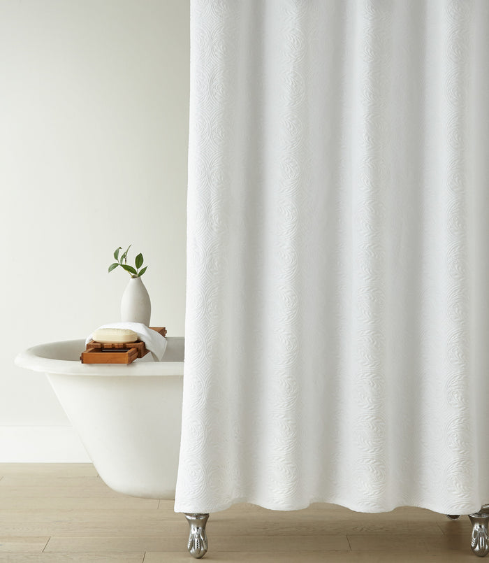 Vienna Matelassé Shower Curtain in a bathroom setting with a white bathtub and decorative items, White