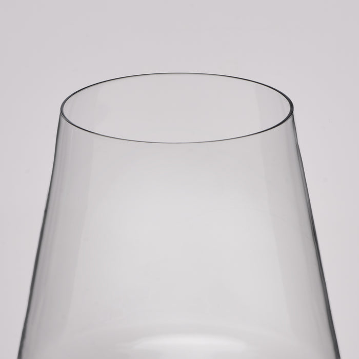 Close-up of a clear glass vessel, likely a wine glass or vase, showing the top rim and tapered transparent body against a light gray background.