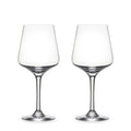 Two empty clear wine glasses with tapered bowls and thin stems on white background.
