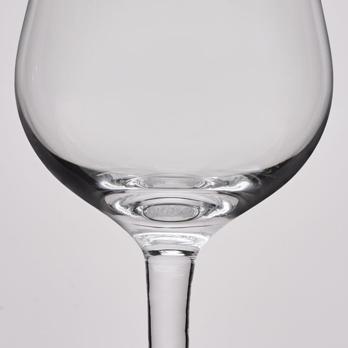 Close-up of a clear glass wine glass showing the bowl base and stem against a light gray background.