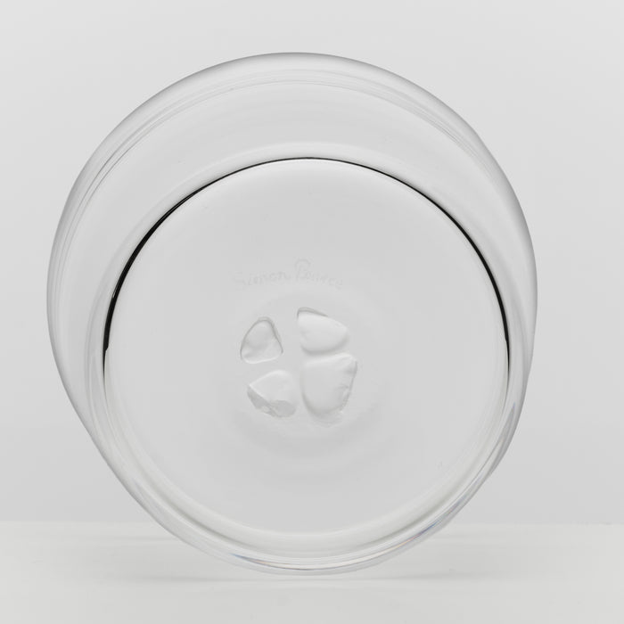 A clear glass bowl viewed from the bottom on a light gray background.