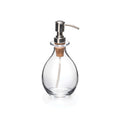 Clear glass soap dispenser with chrome pump, cork collar, and curved teardrop-shaped bottle body.