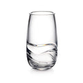 Clear glass tumbler with curved wavy design detail on lower half and tapered sides.