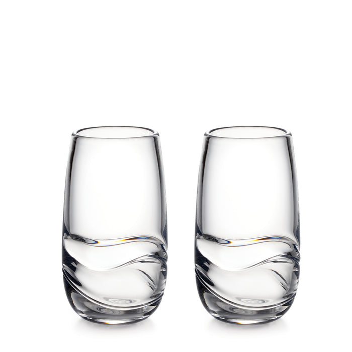 Two clear glass tumblers with curved linear design on lower portion.