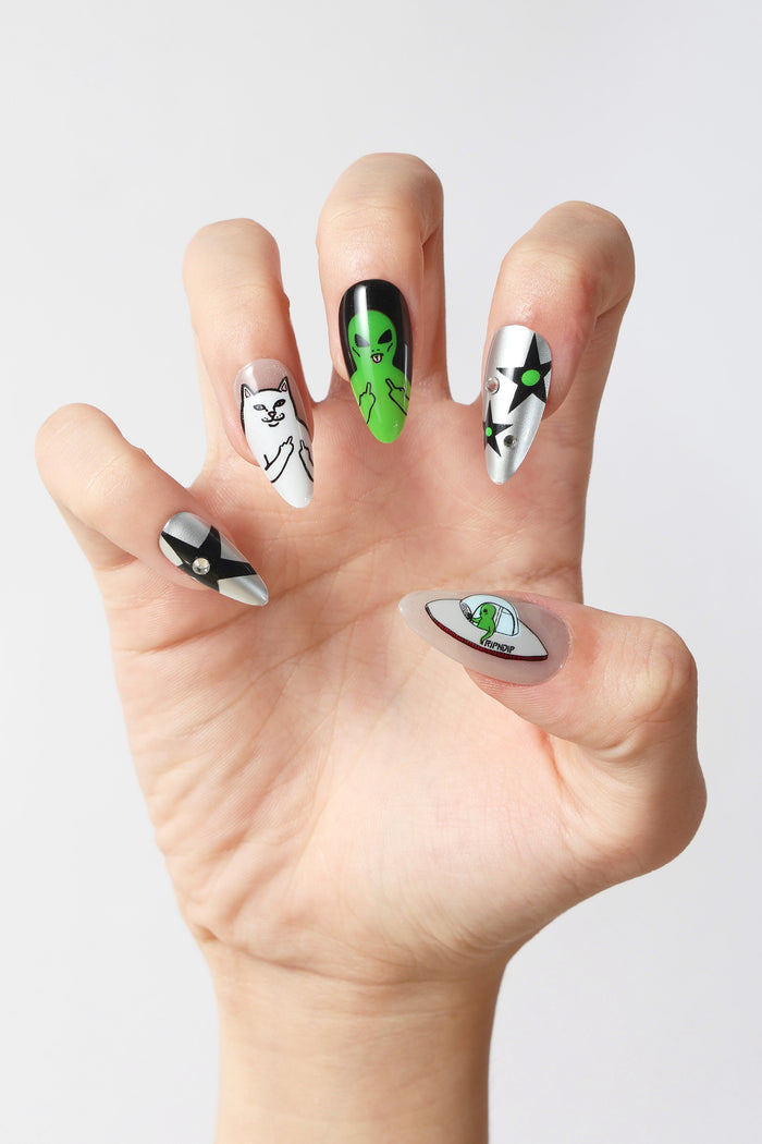 Ripndip "WE OUT HERE" press-on nails: alien, cat, and stars designs.