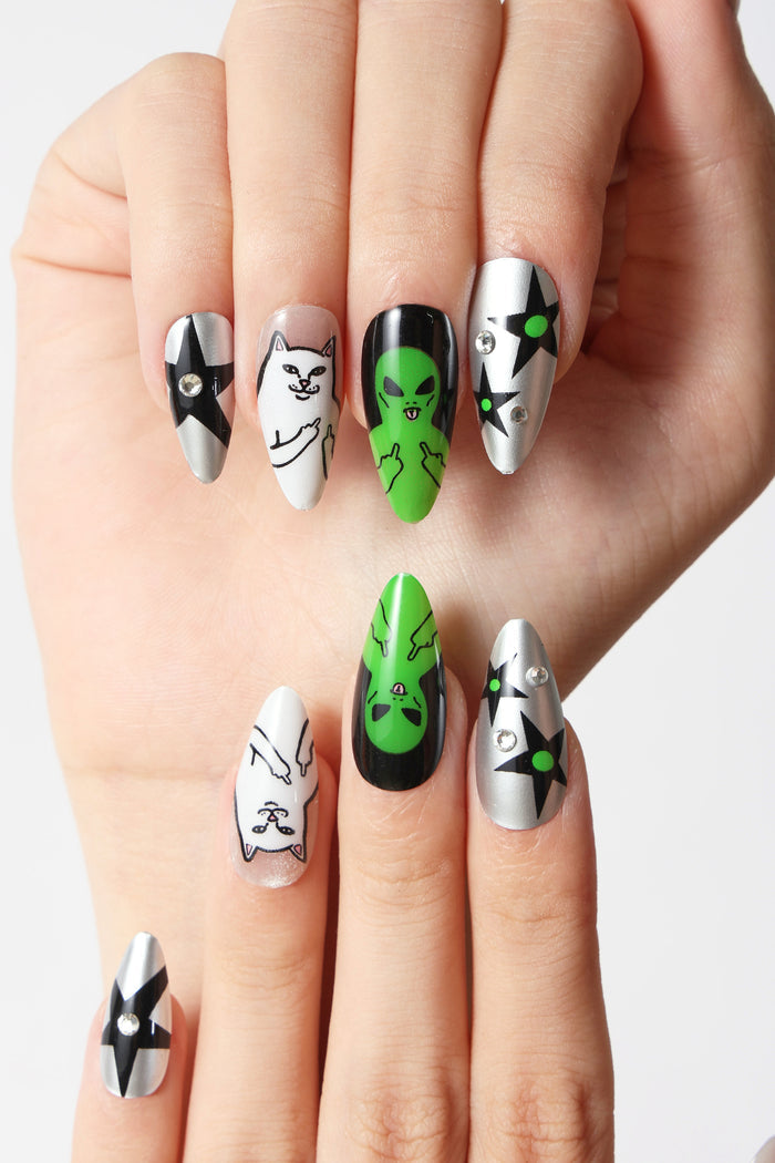 Press-on nails featuring Ripndip cat and alien designs, silver with black stars, and rhinestones.