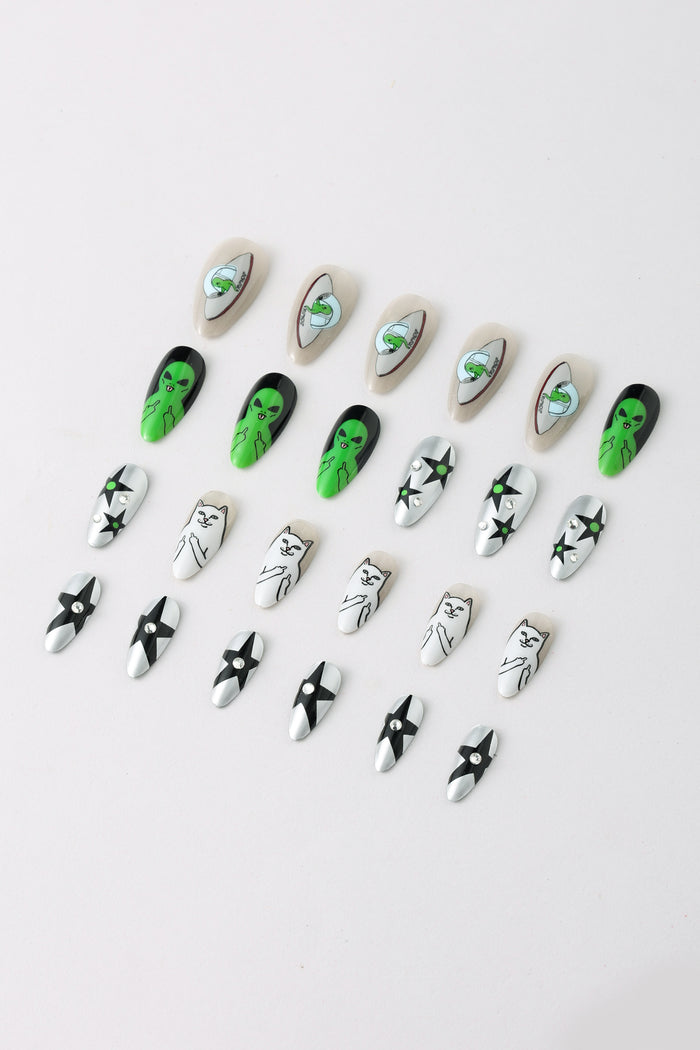 WE OUT HERE Ripndip press-on nails featuring aliens, cats, and stars.