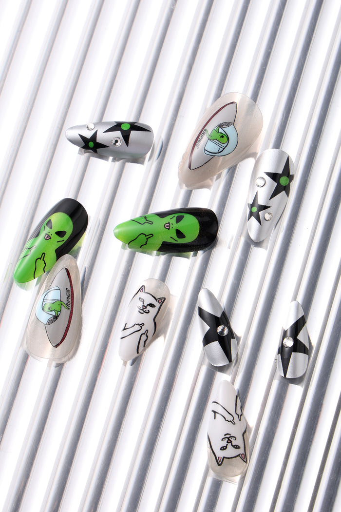 Assorted Ripndip press-on nails featuring alien and cat designs, some with rhinestone accents.