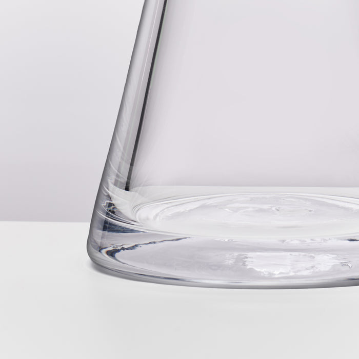 Clear glass bowl with wide rim and tapered sides containing water.