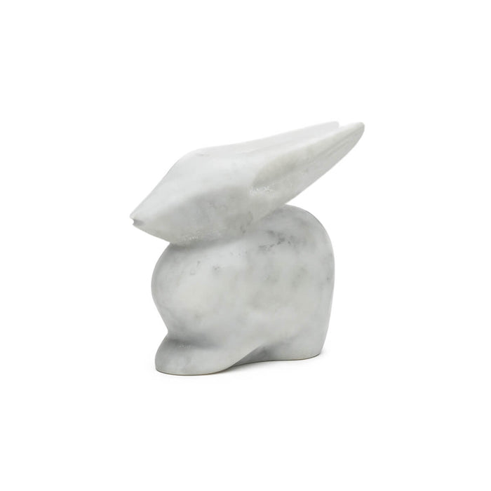 White marble rabbit sculpture with pointed ears and smooth, polished surface.