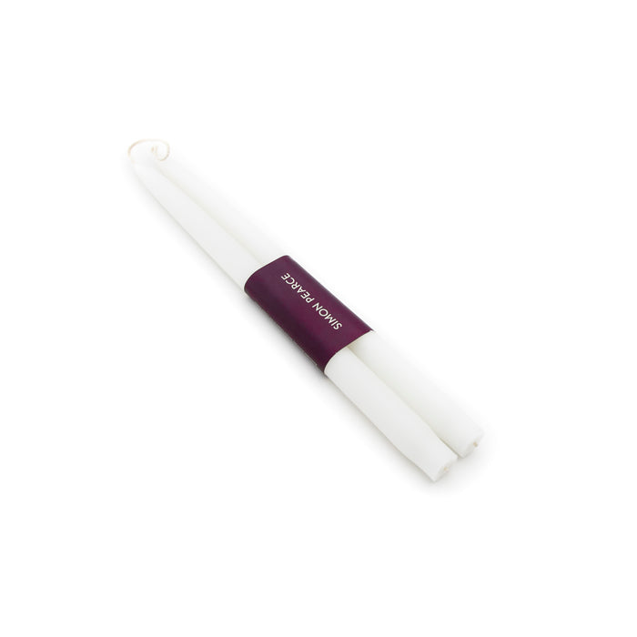 Two white taper candles bound together with a purple label band.