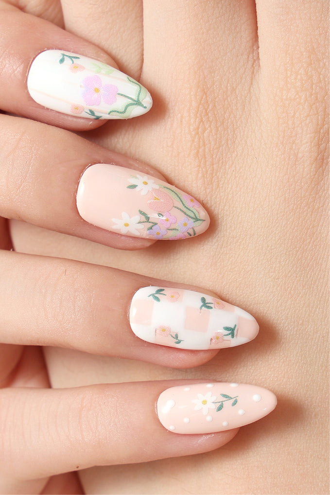 Wildflower Picnic press-on nails by Elaine Lee: delicate floral designs on peach and white.