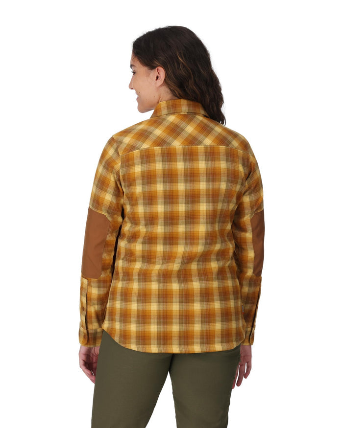 Person wearing a yellow and brown plaid shirt on a white background