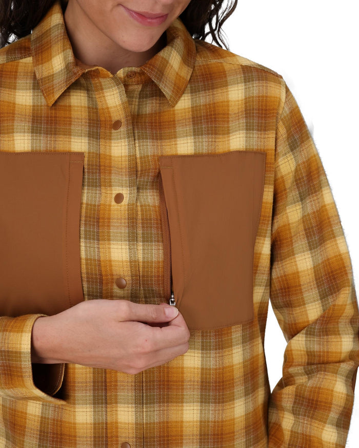 Person wearing a plaid shirt with brown patch pockets on a white background