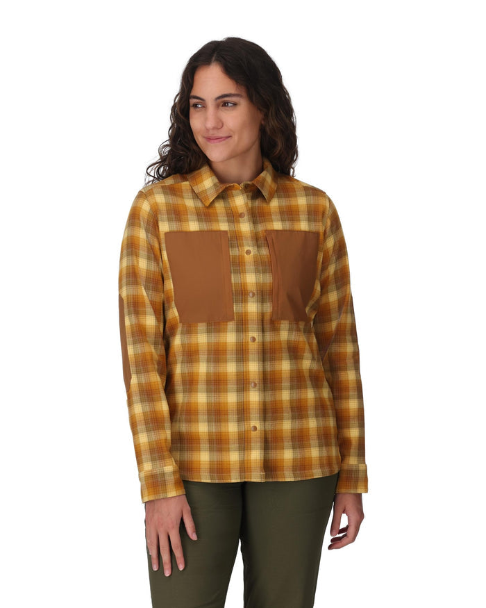 Woman wearing a plaid shirt with brown accents on a white background