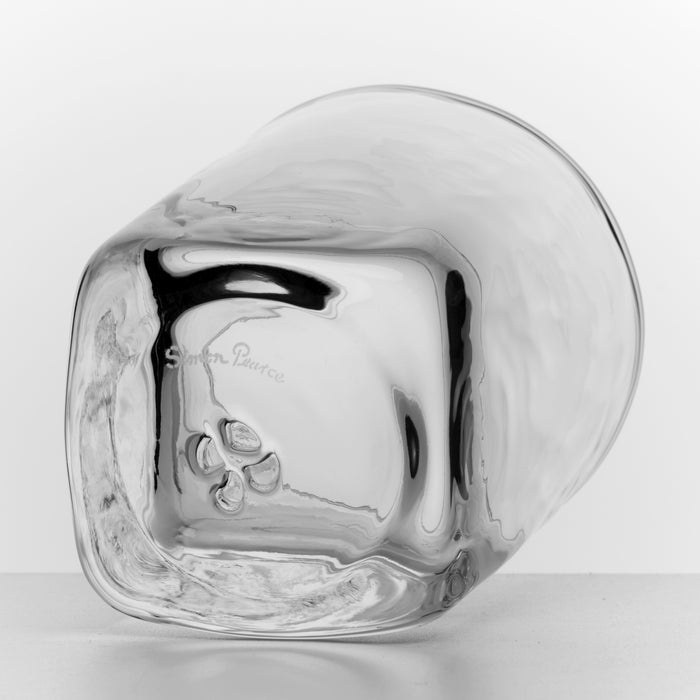 Two clear glass whiskey glasses with embossed floral design on white background.