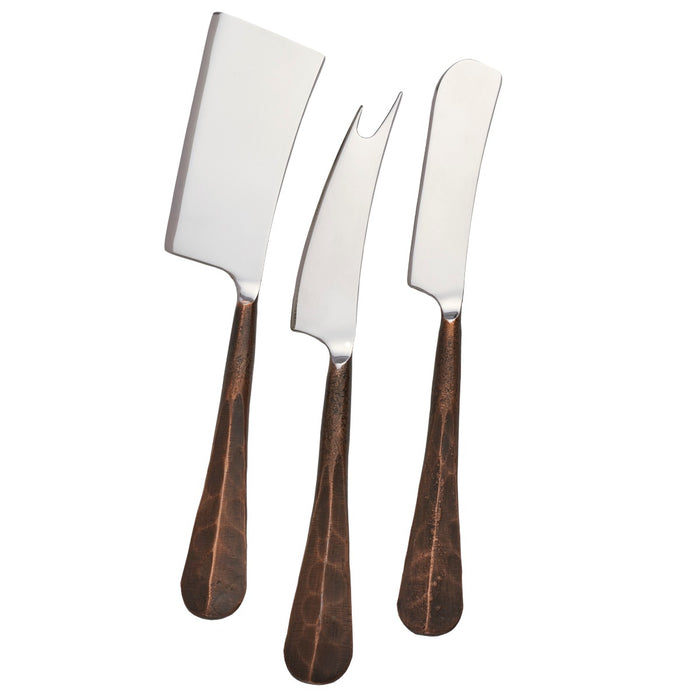 Three stainless steel cheese knives with copper-toned handles in various blade shapes.