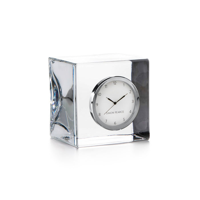 Rectangular clear crystal clock with silver-tone round face, black hands, and numerical markers.