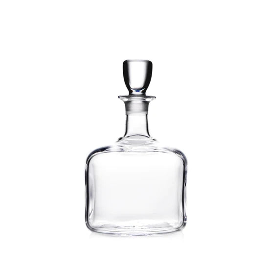 Clear glass decanter with a rounded base, tapered neck, and glass stopper.
