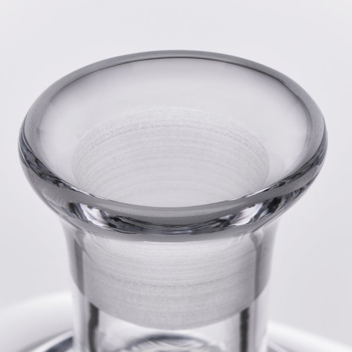Clear glass decanter with wide flared rim and cylindrical body, shown against a light background.
