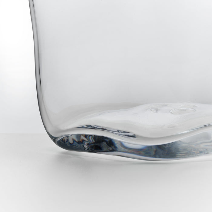 Clear glass ice bucket with curved sides and blue-swirled base detail.
