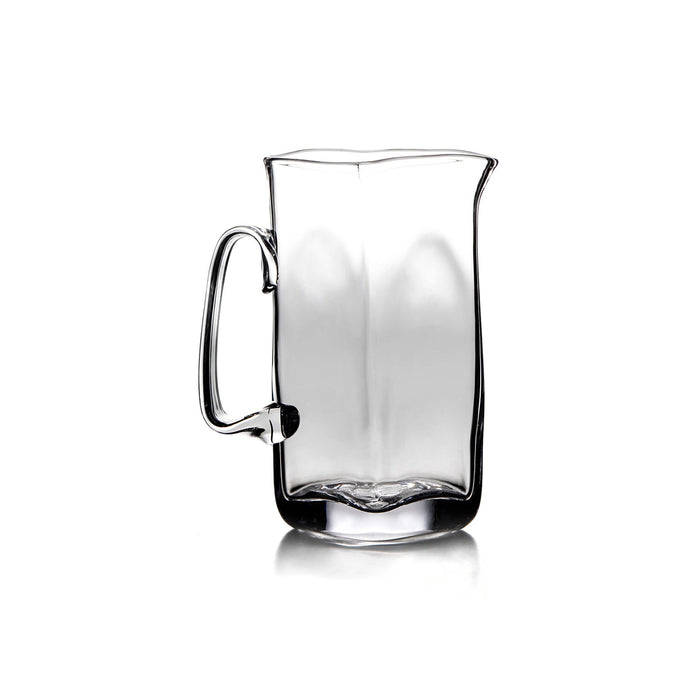 Clear glass pitcher with curved handle and tapered rectangular body.