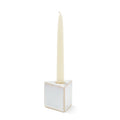 Cream taper candle in white ceramic cube holder with tapered socket.