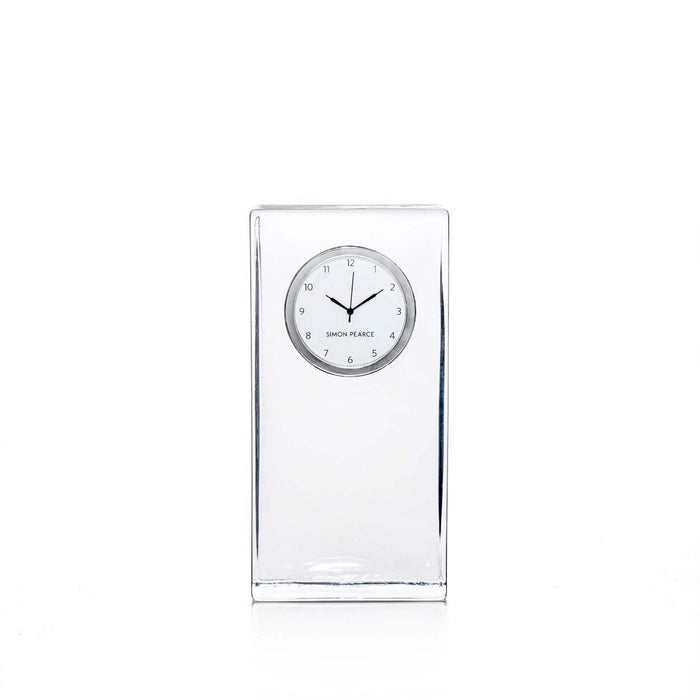 Clear crystal tall clock with round white dial and Arabic numerals, branded Simon Pearce.