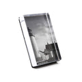 Vertical acrylic photo block displaying black and white lighthouse with attached building image.