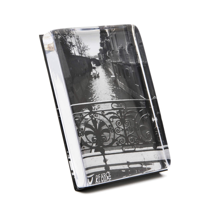 Clear acrylic photo block with black and white canal street scene featuring ornate railing, displayed at an angle.