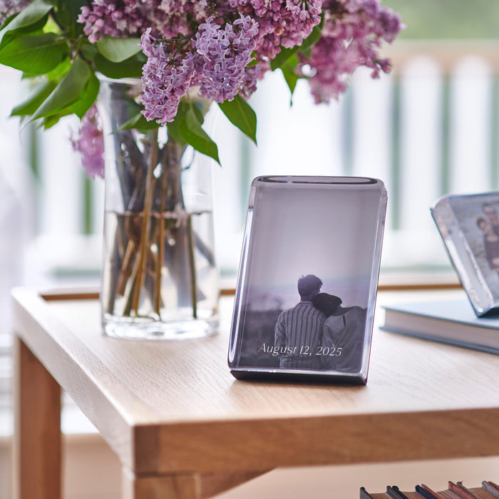 Vertical acrylic photo block displaying a couple from behind with "August 12, 2025" text, displayed on wooden table.
