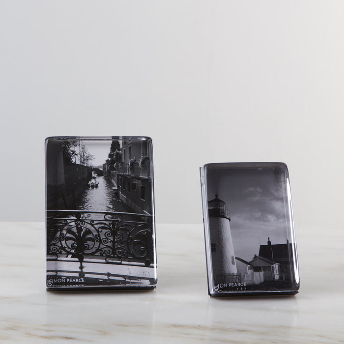 Two black and white photo blocks in vertical orientation displaying architectural images, with clear acrylic fronts.