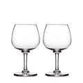 Two clear balloon-shaped wine glasses with stemmed bases.