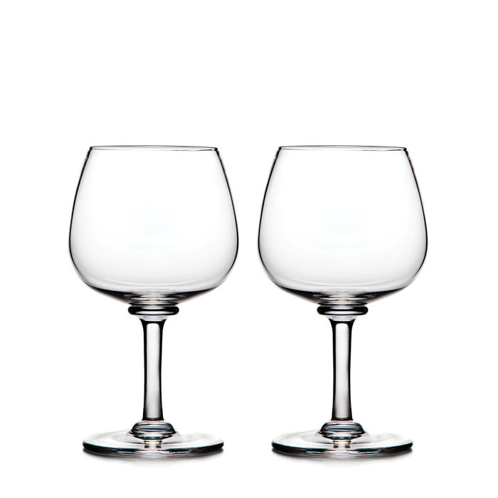 Two clear balloon-shaped wine glasses with stemmed bases.