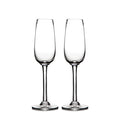 Two clear glass champagne flutes with tapered bowls and stem bases.