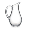 Clear glass pitcher with curved body, angled spout, and thick handle.