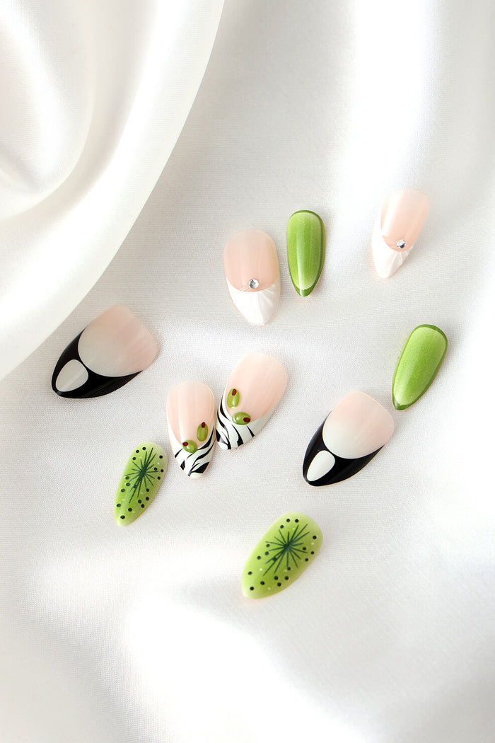 Short almond press-on nails featuring green kiwi designs and zebra stripes